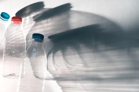 Transparent empty three plastic bottle for ecological recycled backlit by bri Stock Photos