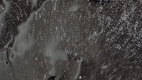 Transparent gel with bubbles on a rotating mirror surface Stock Footage 252195628