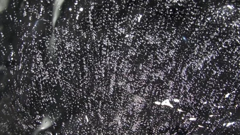 Transparent gel texture with bubbles rotates on the mirror surface Stock Footage 252195663