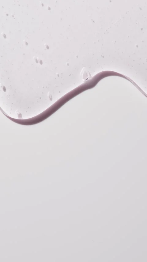 Transparent gel with tiny air bubbles slowly spreads on white background, soft Stock Footage 318974277