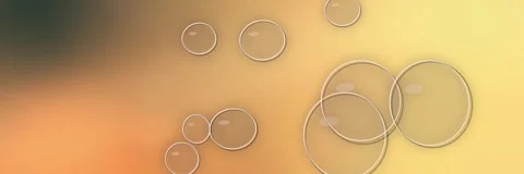 Transparent glass bubbles floating over a golden amber and orange gradient, Stock Footage 340156411