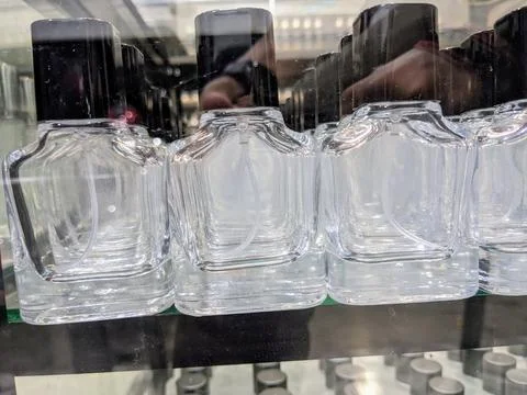 Transparent glass empty bottles in a row, used for perfume refills Stock Photos