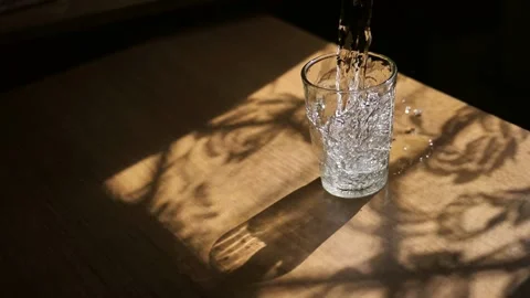A transparent glass is filled with fresh drinking water. Slow motion. Thirst Stock Footage 197112786
