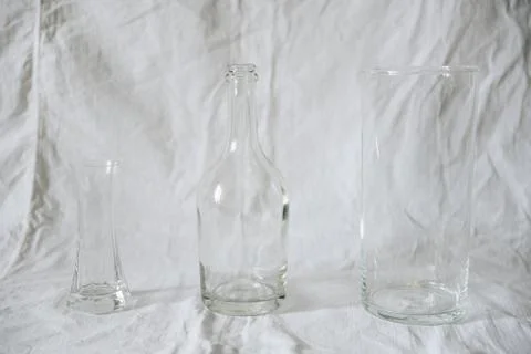 Transparent glassware on a light fabric background Stock Photos