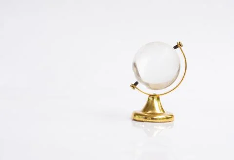 Transparent globe object with gold base on white background Fotos Stock