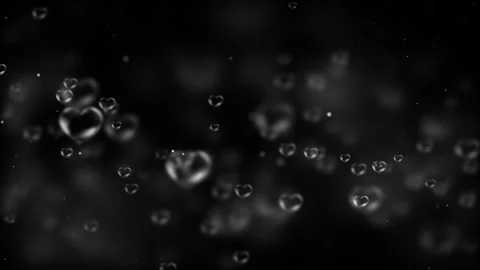 Transparent Heart Bubbles Floating on a Black Background Stock Footage 338436627
