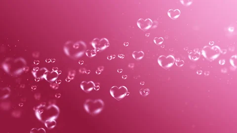 Transparent Heart Bubbles Floating on a Pink Background Stock Footage 338437234