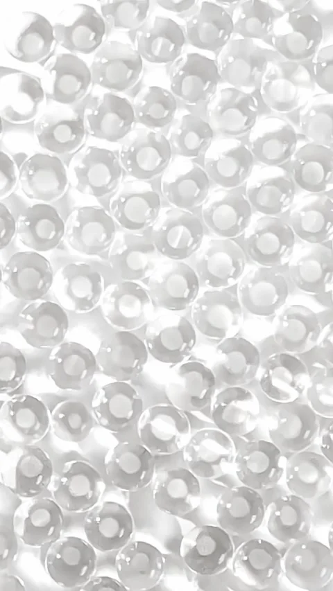 Transparent Hydrogel Beads Creating Shimmering Caustic Reflections Stock Footage 345651184