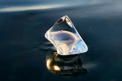 Transparent icicles on a flat surface of ice Stock Photos