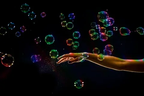 The transparent, iridescent soap bubbles isolated on black. Stockfoto's