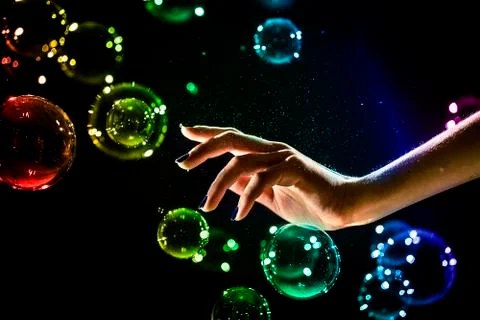 The transparent, iridescent soap bubbles isolated on black. Stock Photos