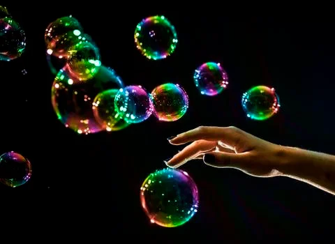 The transparent, iridescent soap bubbles isolated on black. Stock Photos