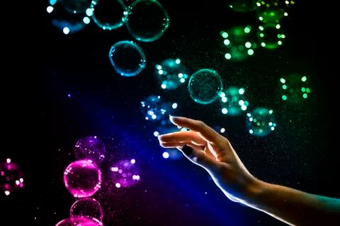 The transparent, iridescent soap bubbles isolated on black. Stock Photos