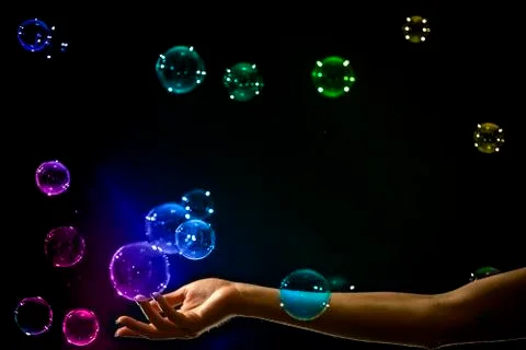 The transparent, iridescent soap bubbles isolated on black. Stock Photos