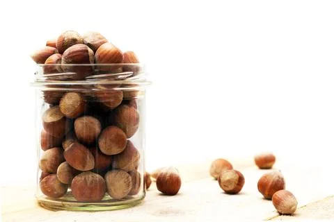 Transparent jar full of hazelnuts Fotos de archivo