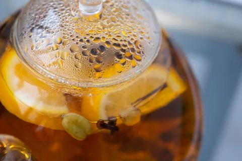Transparent kettle with brewed tea inside. A fogged kettle lid. Droplets of Stock Photos