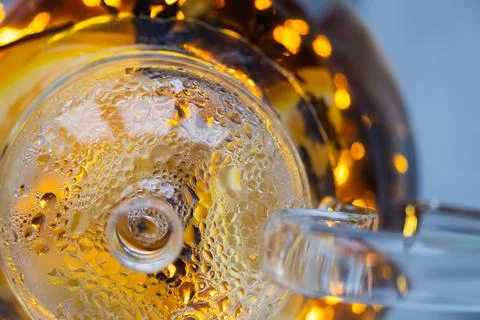 Transparent kettle with brewed tea inside. A fogged kettle lid. Droplets of Stock Photos