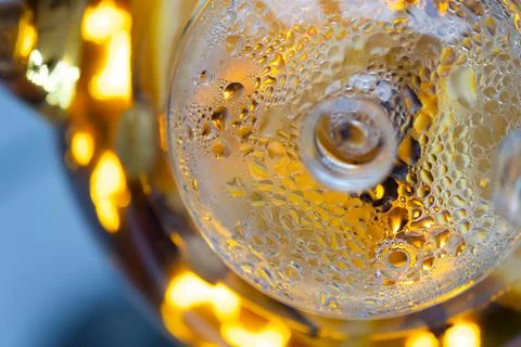 Transparent kettle with brewed tea inside. A fogged kettle lid. Droplets of Stock Photos