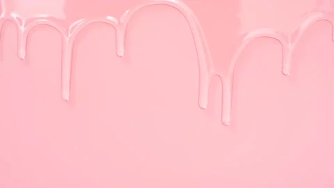 Transparent liquid collagen flowing down on pink background close-up. Stock Footage 194787535