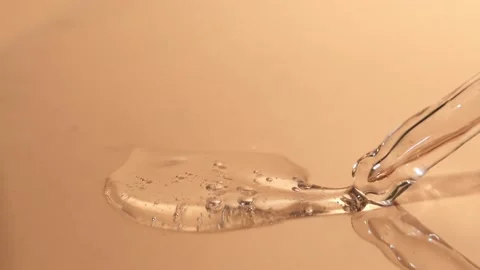 Transparent liquid cosmetic liquid with bubbles and a glass piplan Stock Footage 218314020