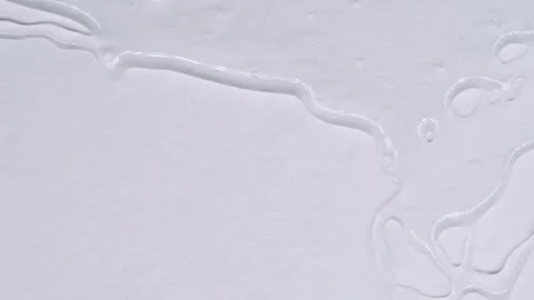 Transparent liquid spreads over a background. Gel texture with bubbles. Stock Footage 171631983