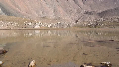 Transparent mountain lake surrounded by rocks Stock Footage 212647512