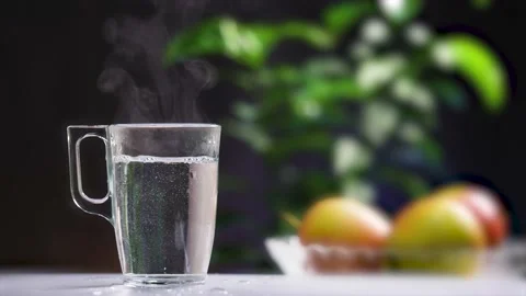 A transparent mug on the table with boiling water. Stock Footage 238844431