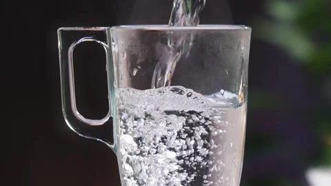 A transparent mug on the table with boiling water. Stock Footage 238844449