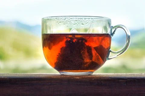 Transparent mug with triangular tea bag Stock Photos