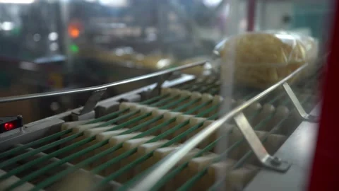 Transparent packages of corn sticks move along the conveyor Stock Footage 195816400