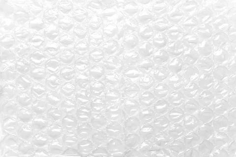 Transparent packaging bubble wrap on white table. Abstract background. Foto stock