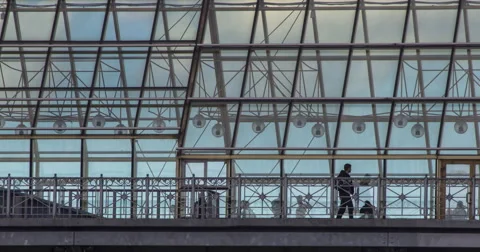 Transparent pedestrian bridge to Central Park in Moscow in sunday evening. Stock Footage 64953380