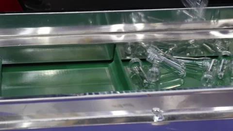 Transparent PET plastic preforms move along automated conveyor belt in mode.. Stock Footage 316698330