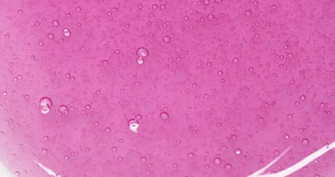 Transparent pink cosmetics serum fluid gel texture with air bubbles, facial mask Stock Footage 213815917
