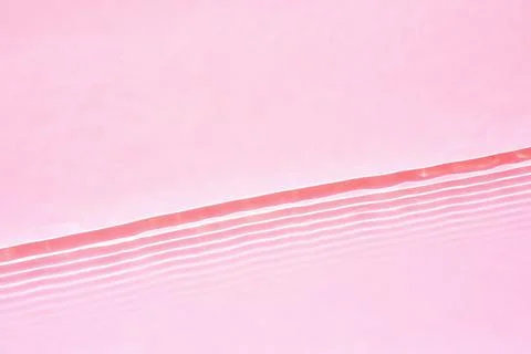 Transparent pink water surface texture with horizontal waves and ripples Stock Photos