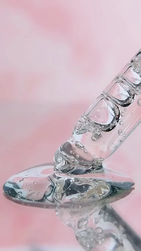 Transparent pipette with clear serum liquid bubbles soft pink background Stock Footage 335296922