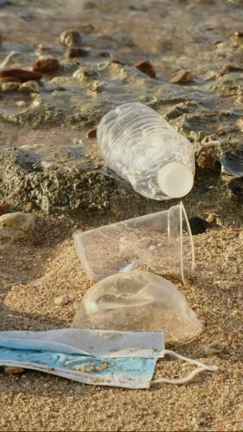 Transparent plastic bottle slowly sinks in blue water of Mediterranean Sea Stock Footage 243183743