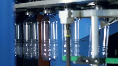 Transparent plastic bottles on automatic machine in bottling factory. Stock Footage 248833629