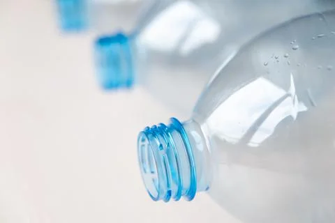 Transparent plastic bottles, on a clear surface. Stock Photos