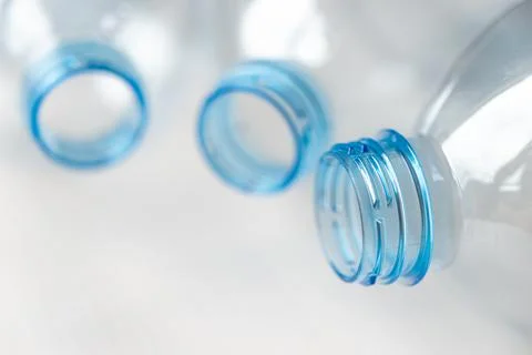 Transparent plastic bottles, on a clear surface. Stock Photos