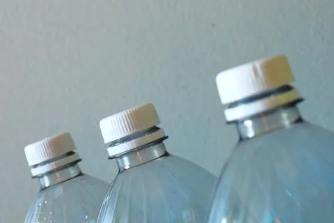 Transparent plastic bottles on a light background Stock Photos