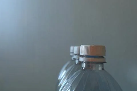 Transparent plastic bottles on a light background Stock Photos