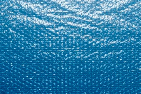 Transparent plastic bubble wrap packing tape colored in trendy classic blue Stock Photos