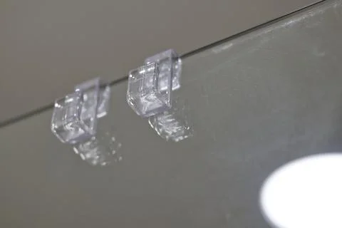 Transparent Plastic Clips on Glass Surface Stock Photos