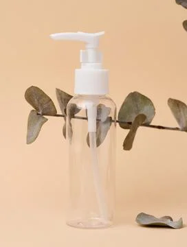 Transparent plastic container for cosmetics on the table, bottle for liquid.. Stock Photos