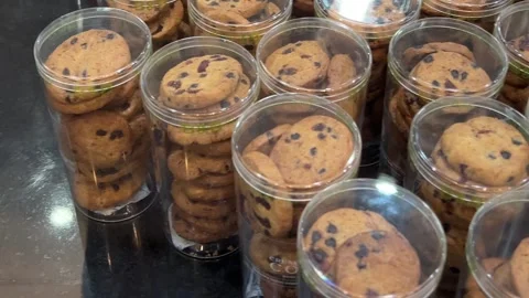 Transparent plastic containers with cookies in the shape of nuts filled with Stock Footage 307371117