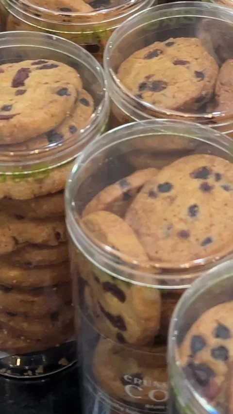 Transparent plastic containers with cookies in the shape of nuts filled with Stock Footage 309256991