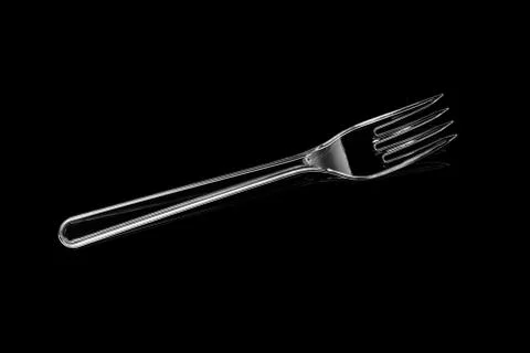 Transparent plastic fork isolated on black background 库存照片