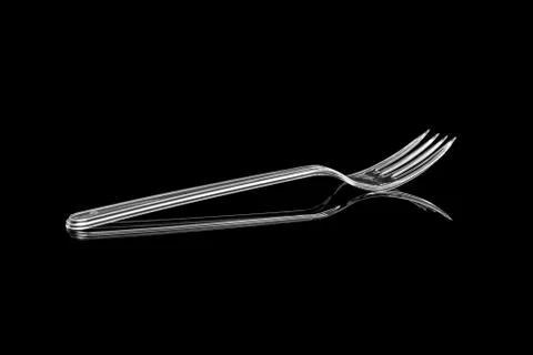Transparent plastic fork isolated on black background Stock Photos