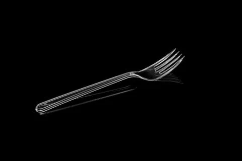 Transparent plastic fork isolated on black background Stock Photos